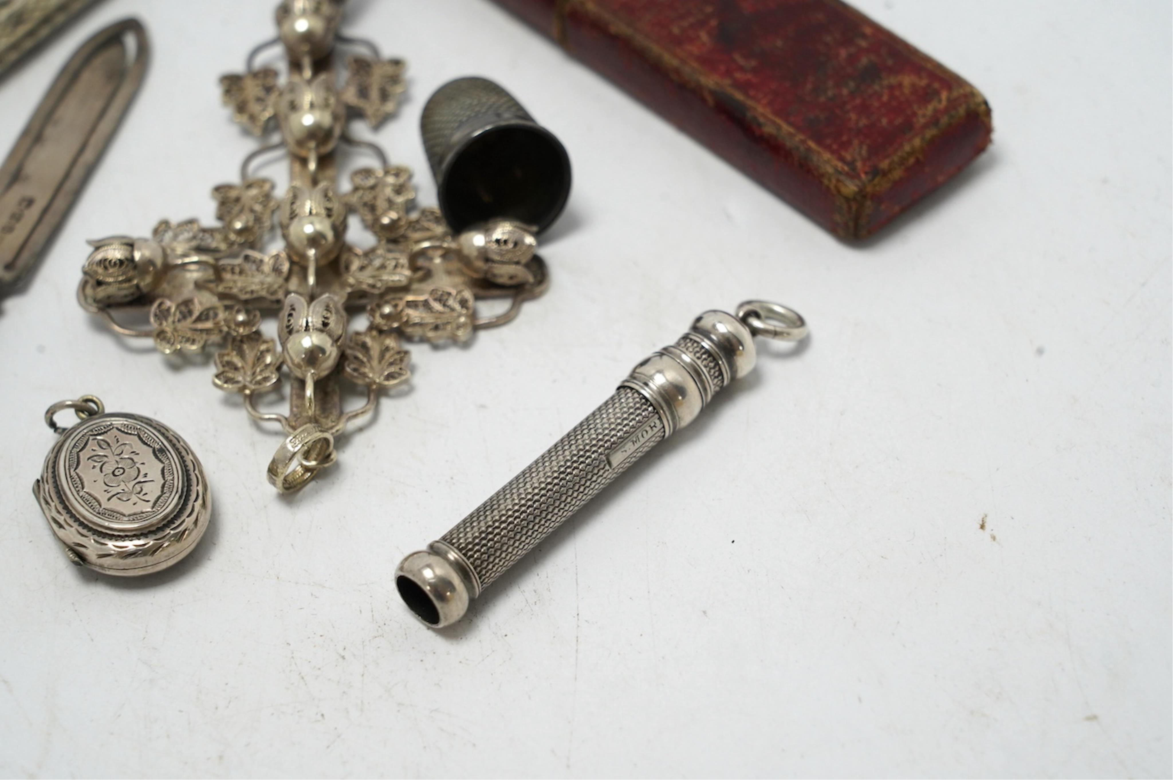Small silver including a Victorian silver and mother of pearl fruit knife, a crucifix, a book mark, pencils, a thimble, etc. Condition - fair